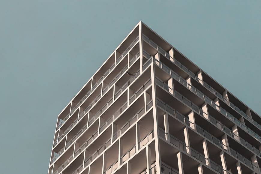 Modern White Apartment Building Against Blue Sky