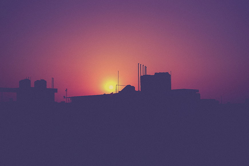 Industrial Silhouette Against Vibrant Purple Sunset Sky