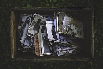 Vintage wooden box filled with old black and white photographs