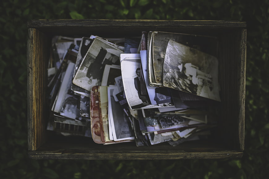 Vintage wooden box filled with old black and white photographs