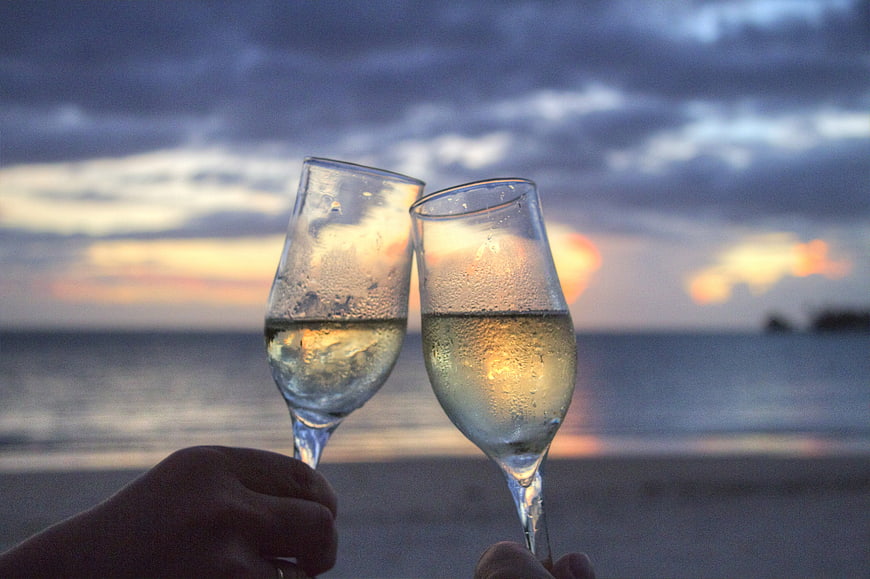 Champagne Toast on Beach at Sunset
