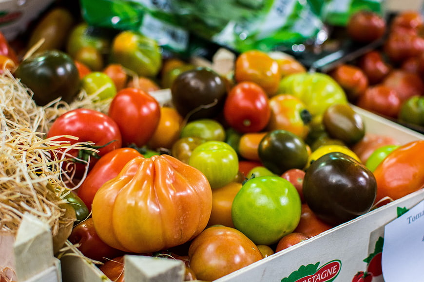 Colorful heirloom tomatoes in a market box