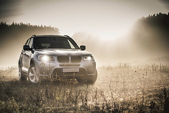 Silver BMW X3 SUV in Misty Field at Dawn