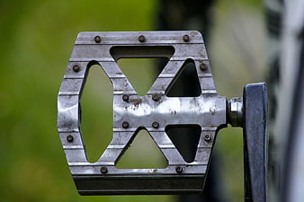Close-up of vintage metal bicycle pedal with geometric cutouts