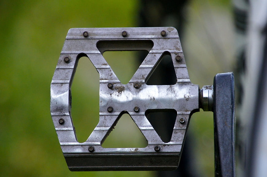Close-up of vintage metal bicycle pedal with geometric cutouts
