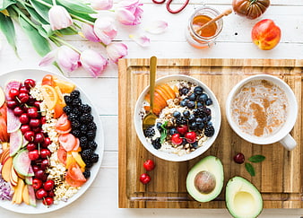 Healthy breakfast with fruit salad, yogurt bowl, and coffee