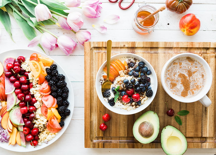 Healthy breakfast with fruit salad, yogurt bowl, and coffee