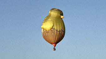 Yellow Chick Hot Air Balloon Flying in Blue Sky