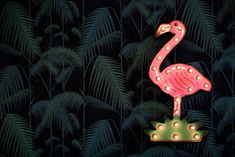 Pink Neon Flamingo Sign Against Dark Tropical Palm Leaves