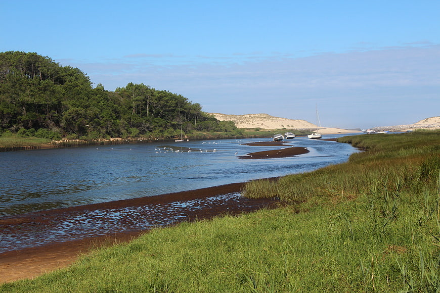 Scenic River Landscape With Boats And Green Banks