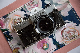 Vintage Argus Cosina STL 1000 Film Camera on Floral Background