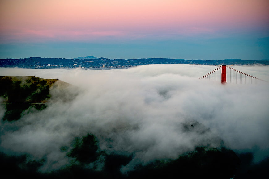 Golden Gate Bridge Emerging from Thick Fog at Sunset