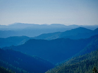 Blue Hazy Mountain Range with Forested Hills