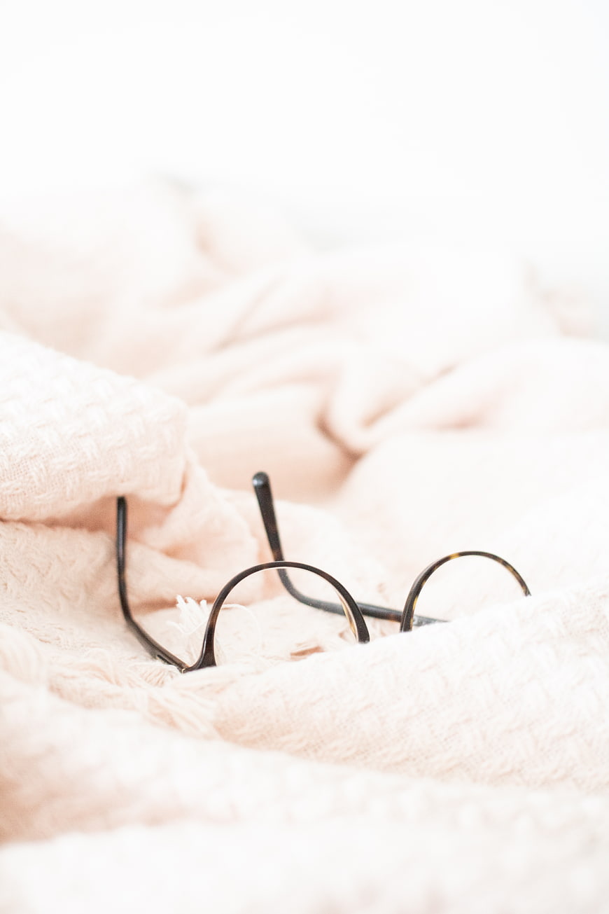 Cozy Glasses on Soft Pink Blanket