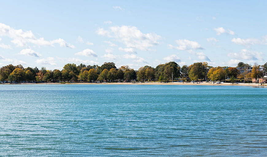 Serene Lake View with Autumn Trees and Blue Sky