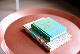Stack of mindfulness books on a terracotta tray