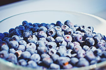 Close-up of fresh blueberries in a glass bowl
