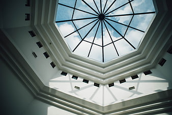 Octagonal skylight with geometric shadows on white ceiling