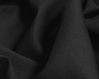 Close-up texture of draped black fabric material