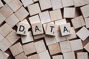 Scrabble tiles spelling DATA on a wooden background