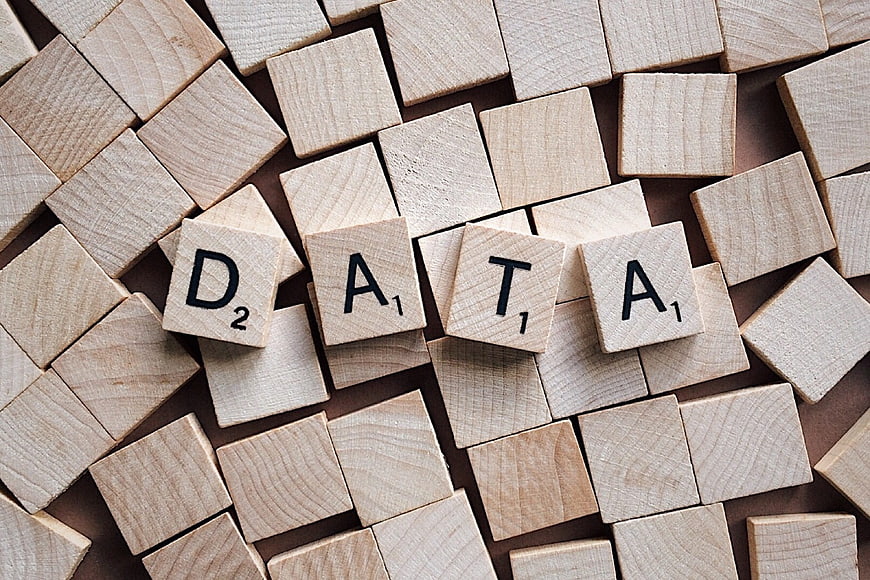 Scrabble tiles spelling DATA on a wooden background