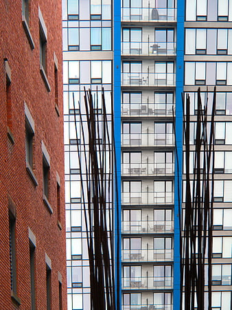 Modern Blue Glass Building vs Red Brick Architecture