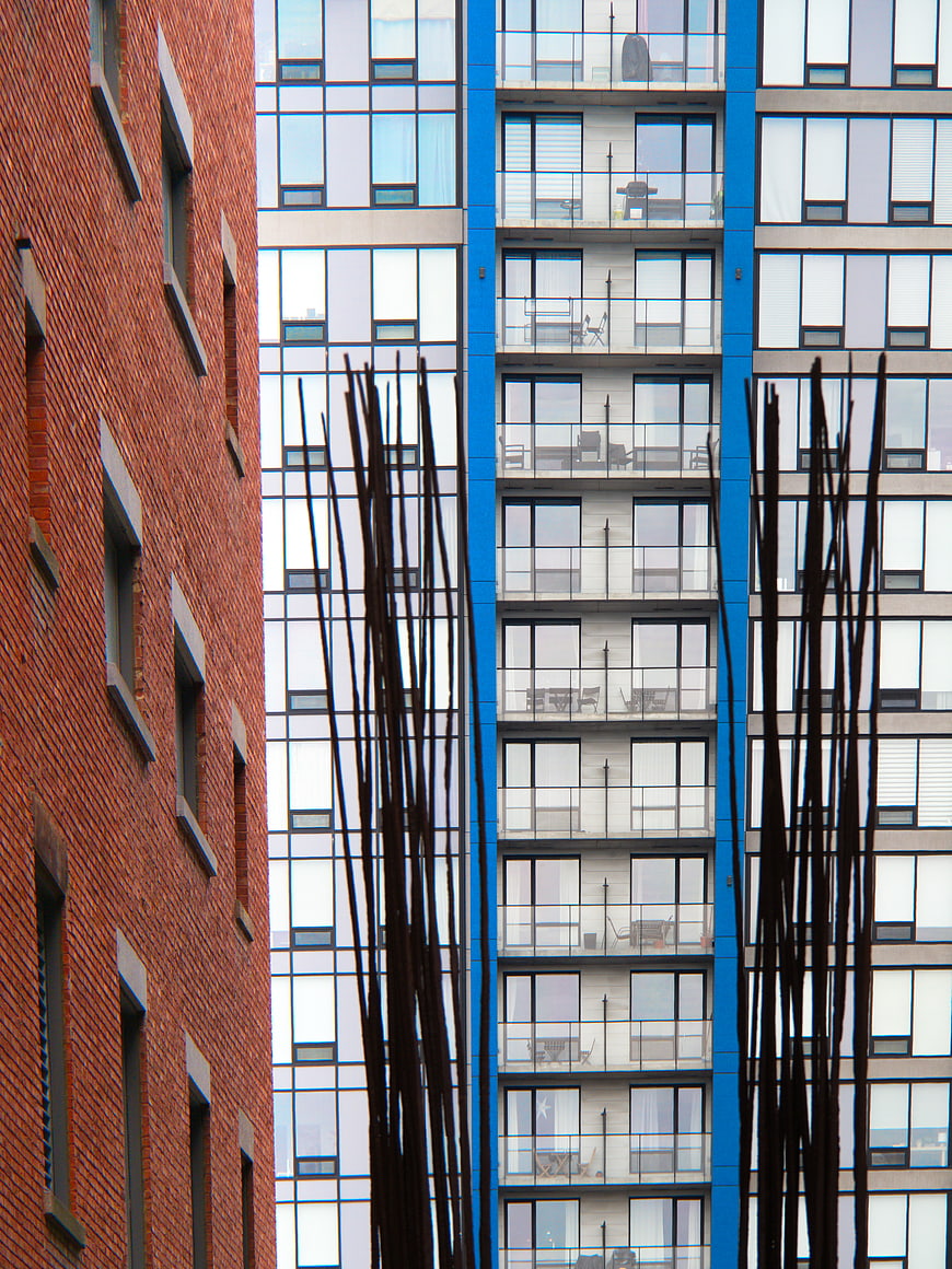 Modern Blue Glass Building vs Red Brick Architecture