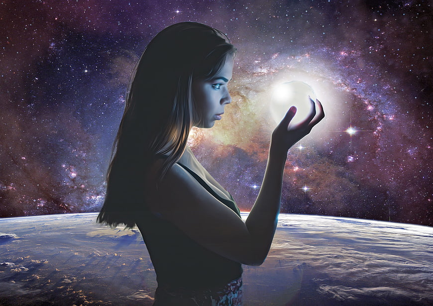 Young woman holding glowing orb against cosmic galaxy background
