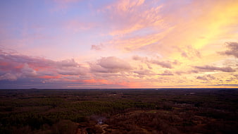 Aerial View of Dramatic Pink and Orange Sunset Over Forest