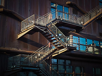 Modern Metal Fire Escape Staircase on Dark Building Facade