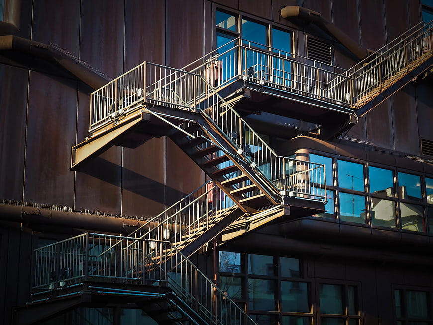 Modern Metal Fire Escape Staircase on Dark Building Facade