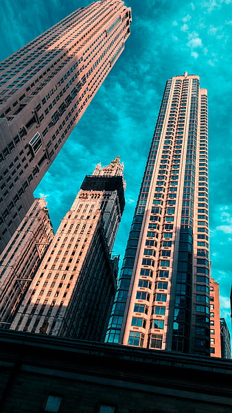 Low angle view of New York skyscrapers against teal sky