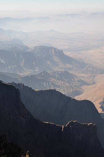 Misty Mountain Landscape with Layered Peaks and Valleys