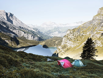 Camping Tents on Alpine Meadow Overlooking Mountain Lake