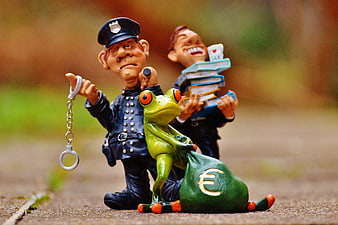 Police officer arresting frog with money bag and tax evasion concept