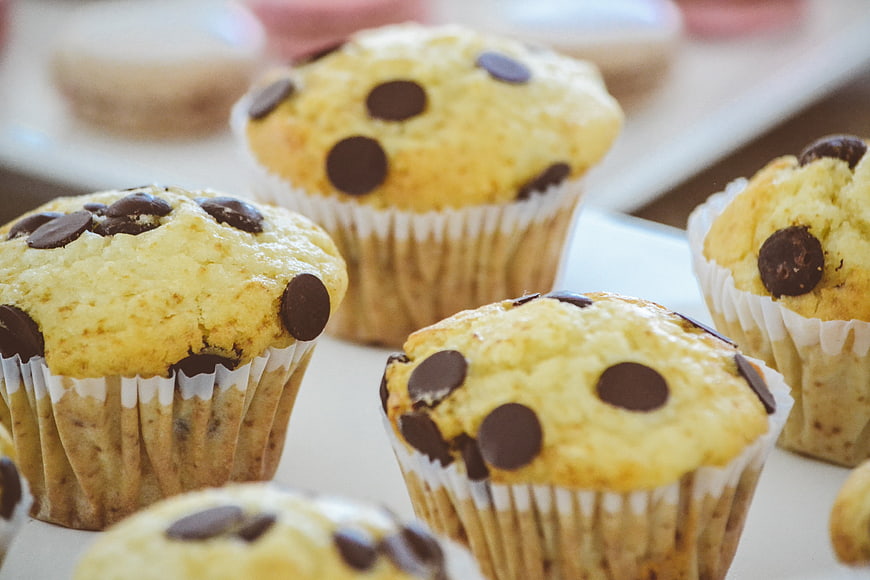 Close-up of fresh chocolate chip muffins on a white plate
