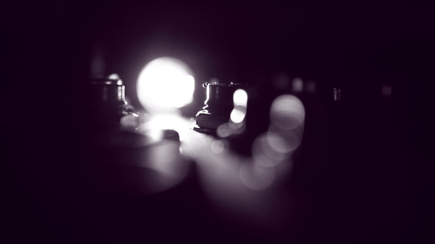 Abstract dark bokeh lights with purple tint