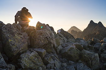 Hiker Silhouette on Rocky Mountain Summit at Sunrise
