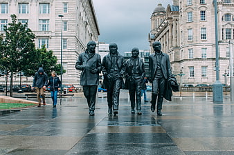 The Beatles Statue Walking on Wet Pavement in Liverpool