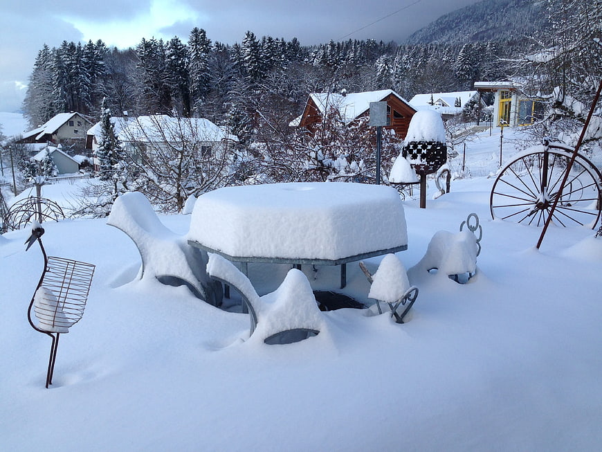 Snow-covered garden furniture in winter village