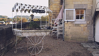 Vintage white herb cart on stone terrace with village view