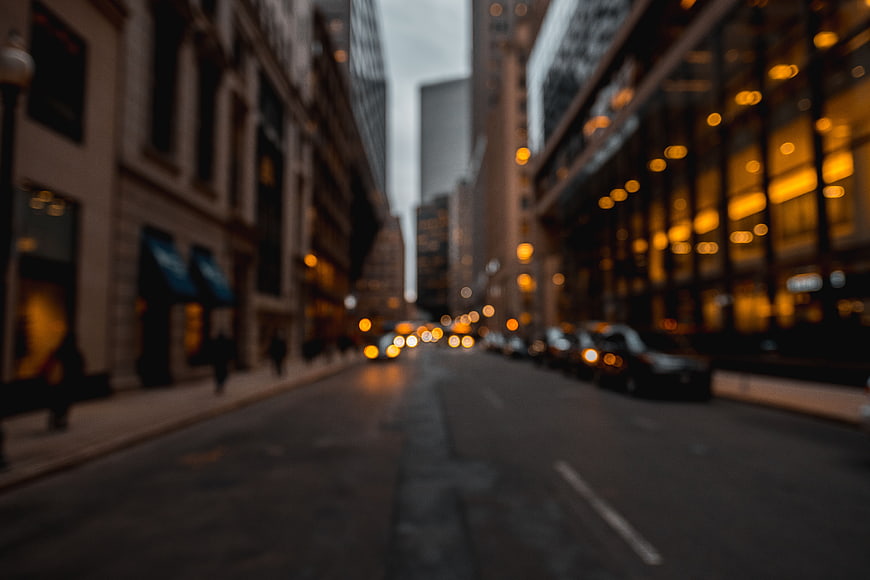 Blurred City Street with Bokeh Lights and Urban Architecture