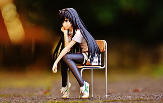 Anime Figure of Girl Sitting on Chair in Park