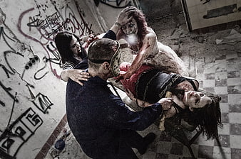 Horror scene with masked killer and bloody zombies in abandoned room