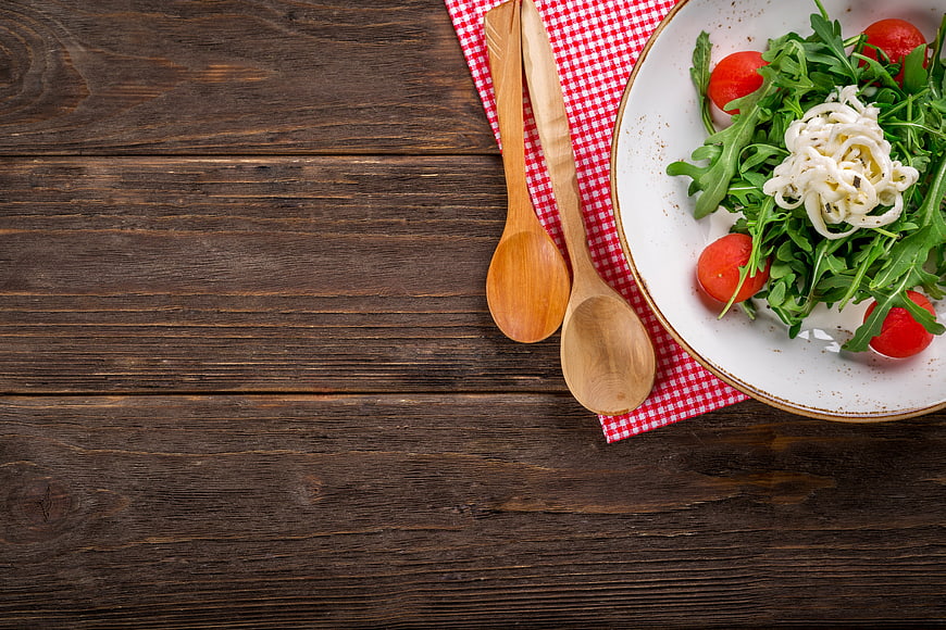 Fresh Arugula Salad with Cherry Tomatoes on Wooden Table