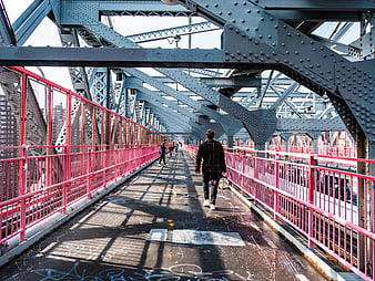 Pedestrians Walking on Industrial Bridge with Pink Railings
