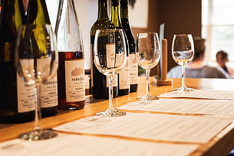 Wine tasting setup with bottles and glasses on wooden table