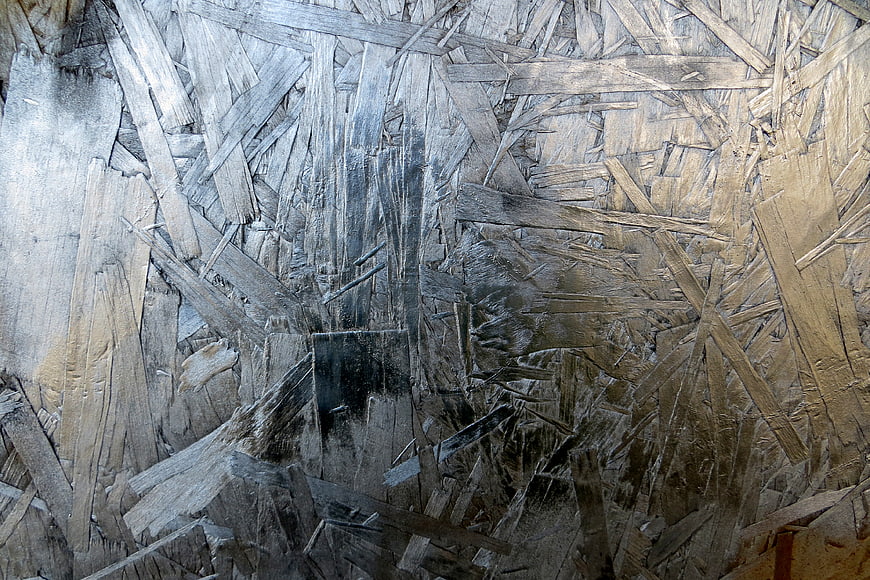 Close-up texture of weathered oriented strand board plywood