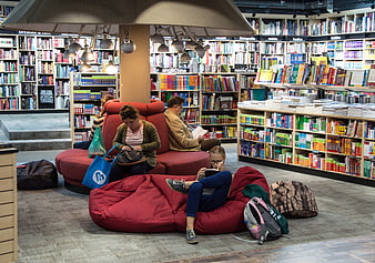 People reading and relaxing on bean bags in a modern bookstore