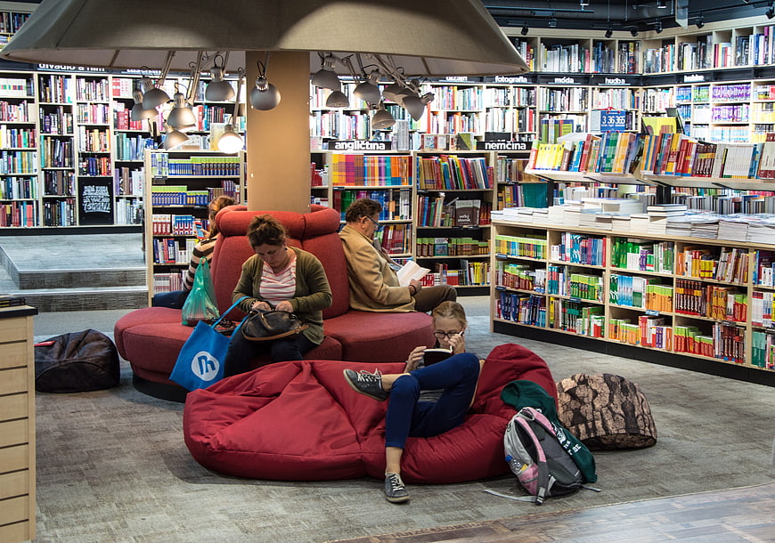 People reading and relaxing on bean bags in a modern bookstore